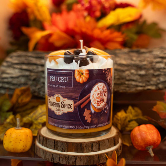 Pumpkin spice candle with a fall-themed background featuring pumpkins and leaves.