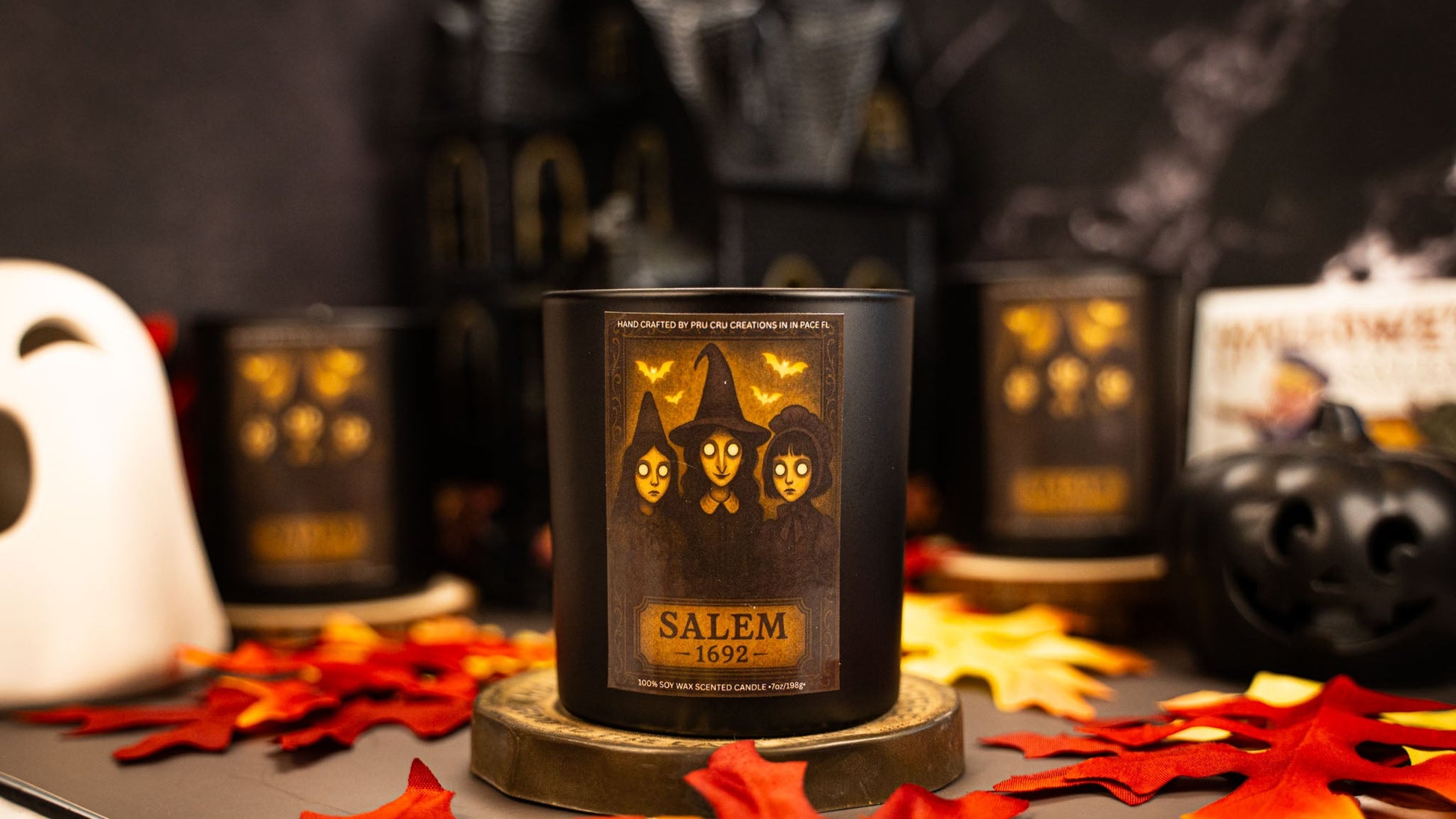 Salem-themed candle with Halloween decorations in the background